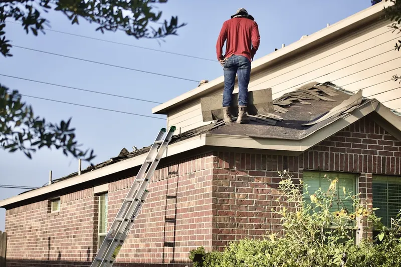 Professional roofer working on a residential roof in Greensboro